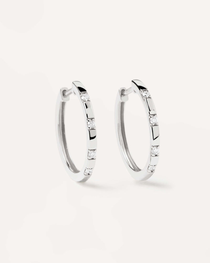 Solid white gold hoop earrings set with lab-grown diamonds of 0.12 carats in total