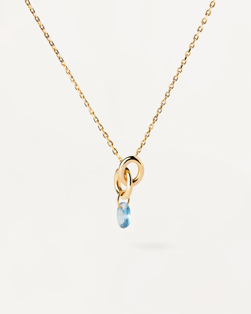 Gold-plated necklace featuring two interlinked rings with a blue zirconia drop pendant