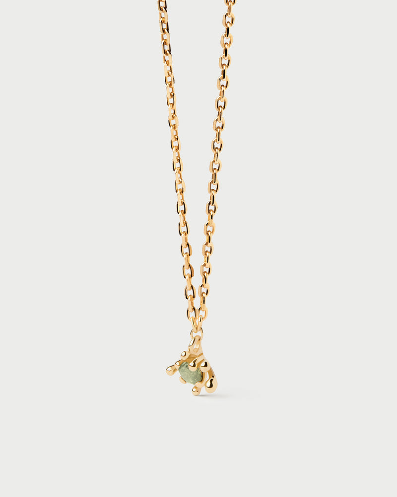 Sleek chain necklace set with green zirconia surrounded by golden multi-prong setting