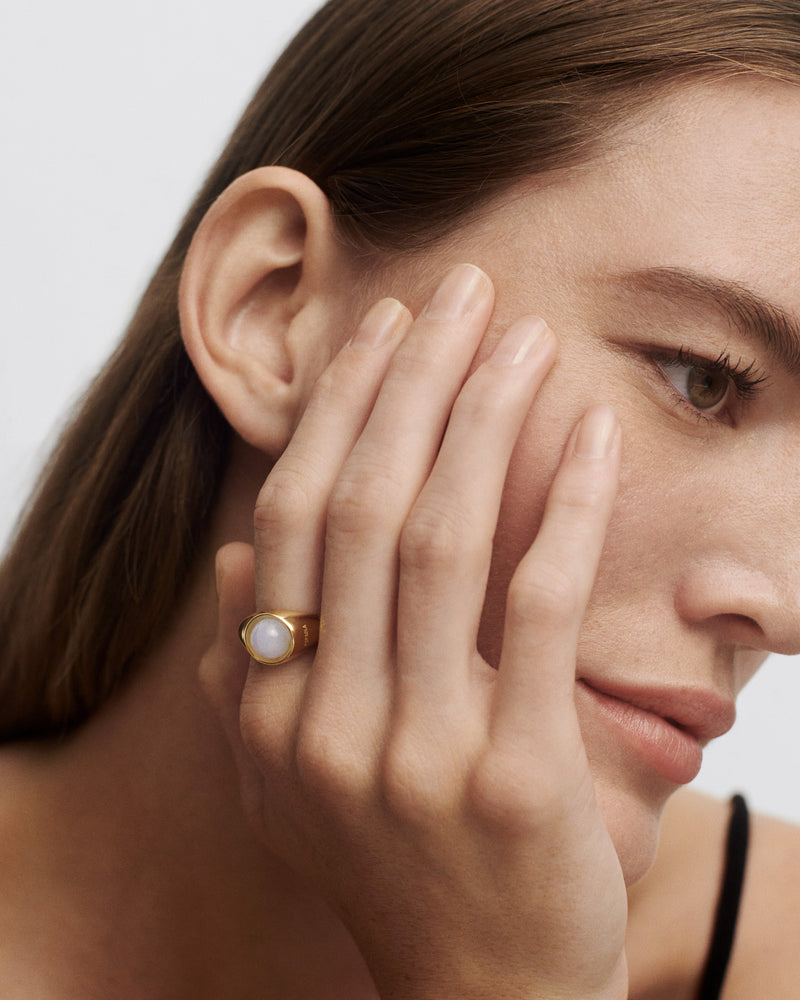 Gold-plated half-sphere signet ring topped with an oval blue gemstone