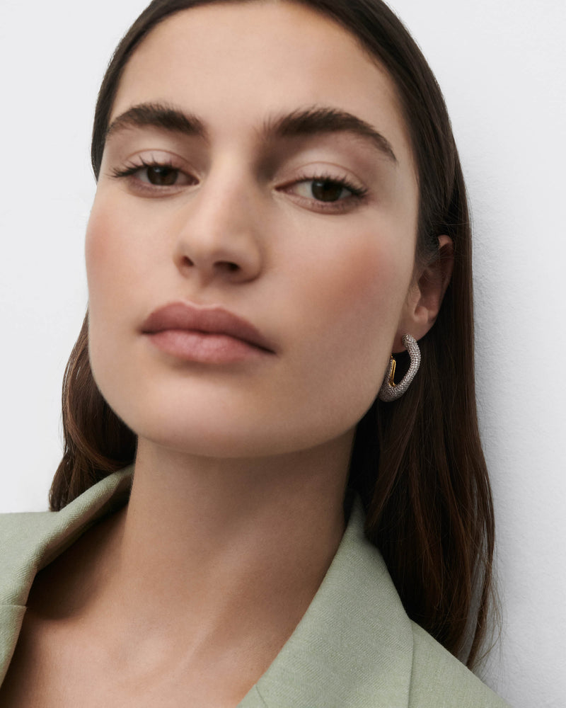 Gold-plated sculptural hoop earrings with abstract design set with pavé zirconia