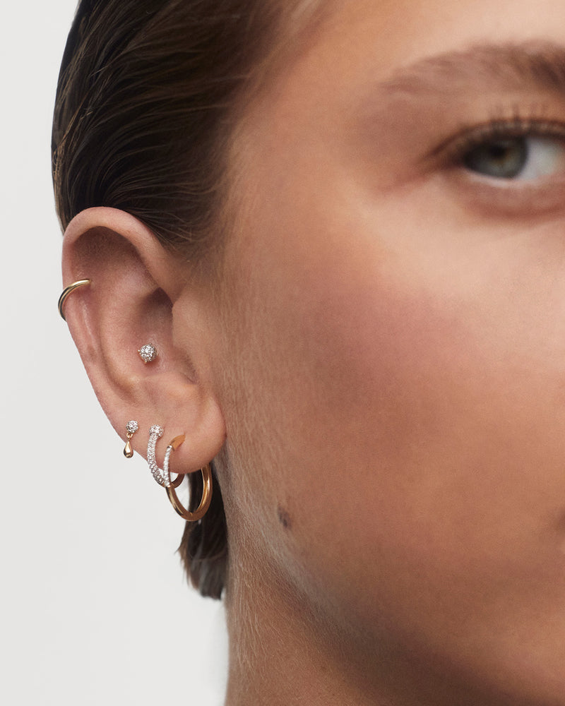 Minimalist round stud earrings in solid yellow gold set with a pavé lab-grown diamond