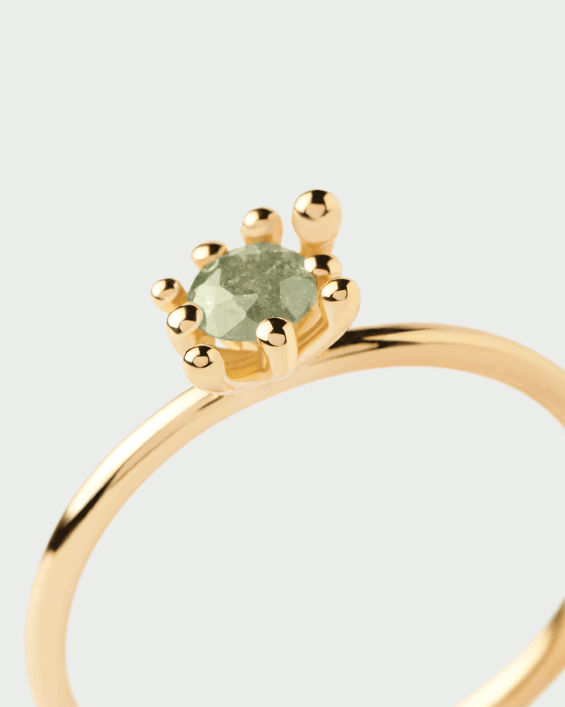 Gold-plated organic ring set with iced green zirconia surrounded by multi-prong setting