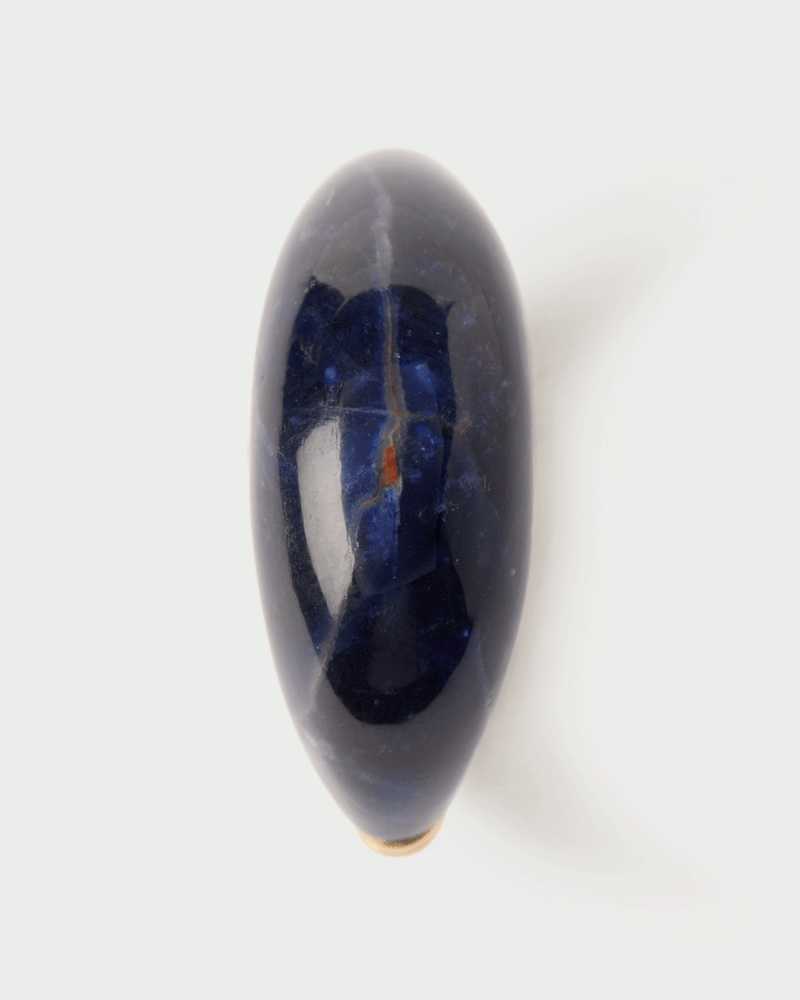Chunky stamp ring topped with an oval hand-carved royal blue gemstone