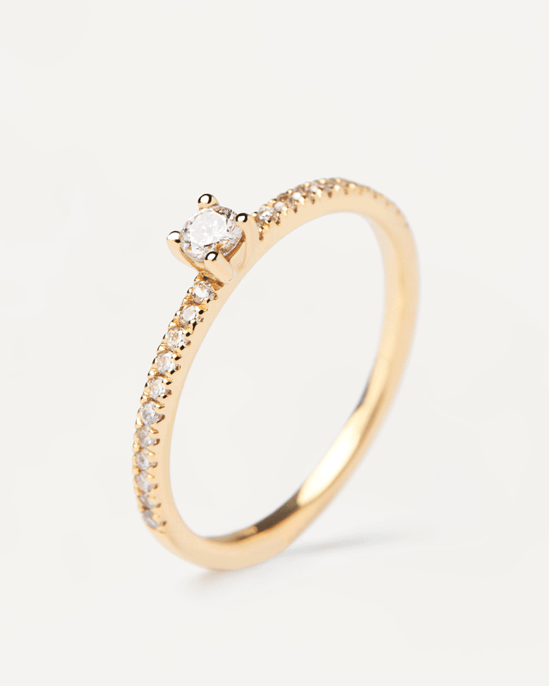 Solid yellow gold ring with a lab-grown diamond eternity band and a round cut center diamond, making 0.31K