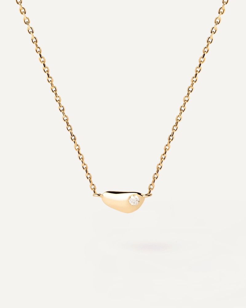 Gold-plated minimalist fluid shape necklace embellished with a flush set zirconia pendant